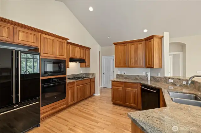 Granite countertops and maple cabinets.
