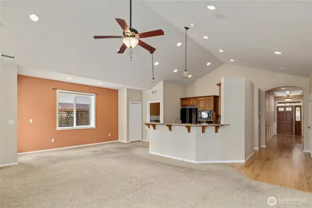 Looking from living room towards kitchen and front entry.