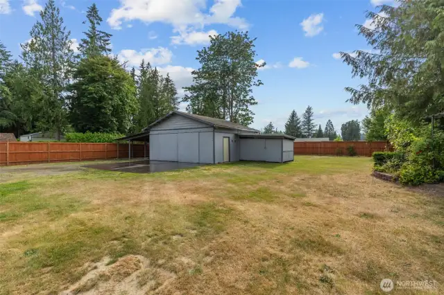 new fenced back yard with shop/garage