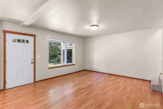 Large open living space connected to dining area and kitchen