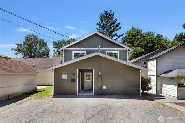 Back of home where main entrance and parking is located on the alley way off Potter Street. 2 large storage units for home, located on both sides of the entry.