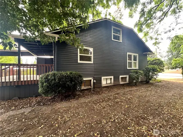 View of side of home, there is a spacious deck
