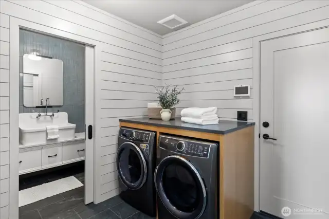 Washer and dryer on the main level are paired with a thoughtfully designed drop zone, creating a mudroom-style entry that elevates everyday living.