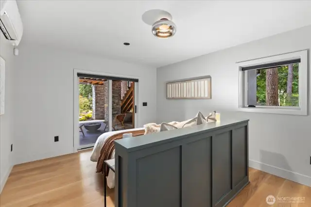 Lower level ADU bedroom features built-in headboard and water views