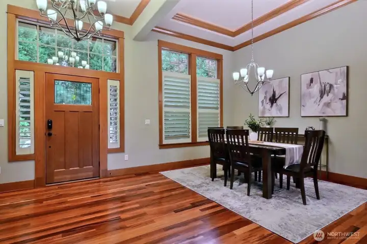 Entry with gleaming hardwood floors & dining area