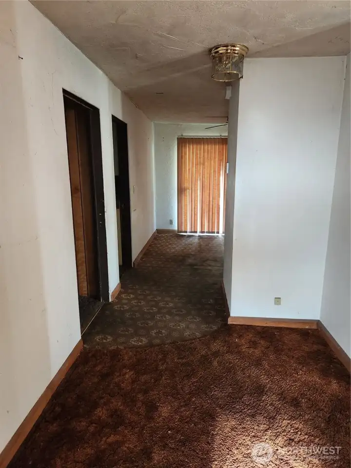 Entry way, Bedroom and bathroom access on Left along with Laundry rm access, Dining rm straignt ahead, Kitchen to Right of Sliding glass door and Living rm access on Right