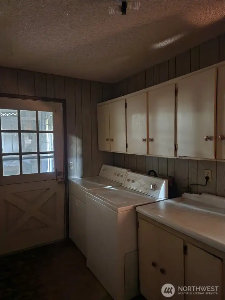 Laundry and Utility rm with ample storage. Washer and Dryer stay with home.