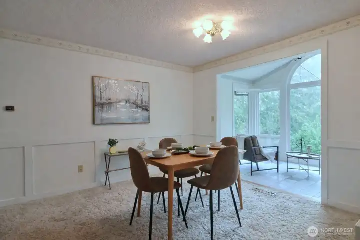 This nice-sized dining room seamlessly joins the living room with the kitchen with the sunroom addition.