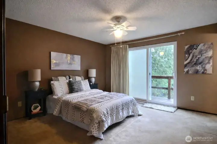 Peaceful, calming primary suite with a small deck area that overlooks the private backyard - the perfect place to wake up!