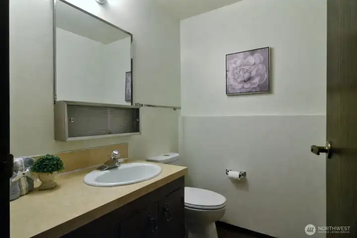 This half bath with new toilet is located on the lower level.
