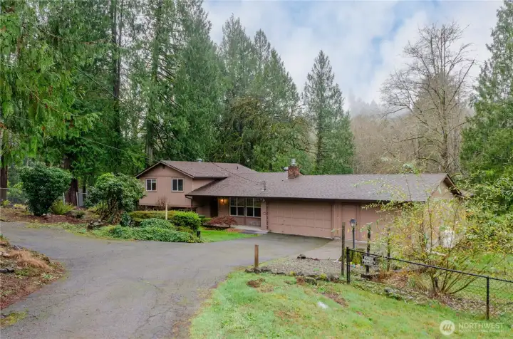 The driveway is good-sized and includes additional parking to the left.