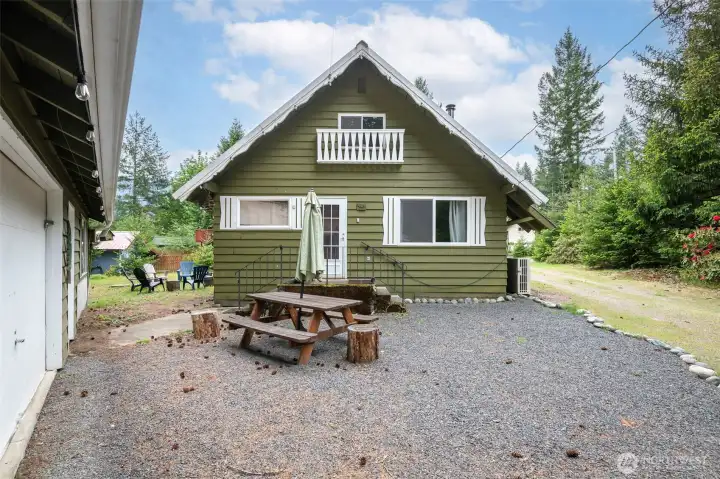 The main entrance welcomes you with cabin charm, cozy details, and direct access to the outdoor gathering space.