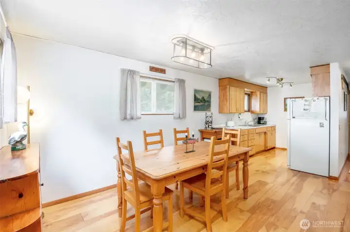 Warm-toned, wide-plank hardwoods and midcentury cabinets provide cabin vibes.