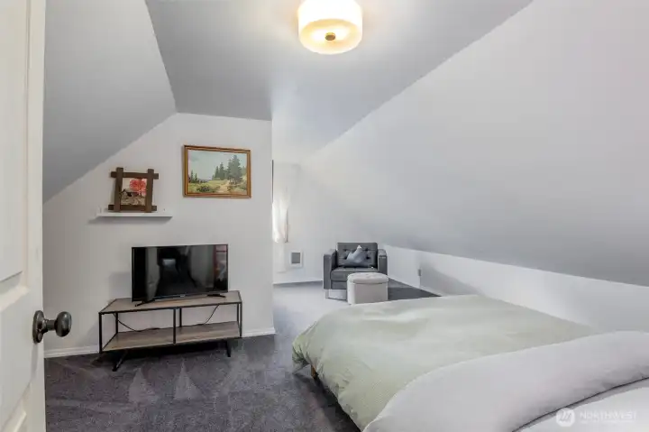 Second upstairs bedroom is equally roomy and features a connected half bathroom.