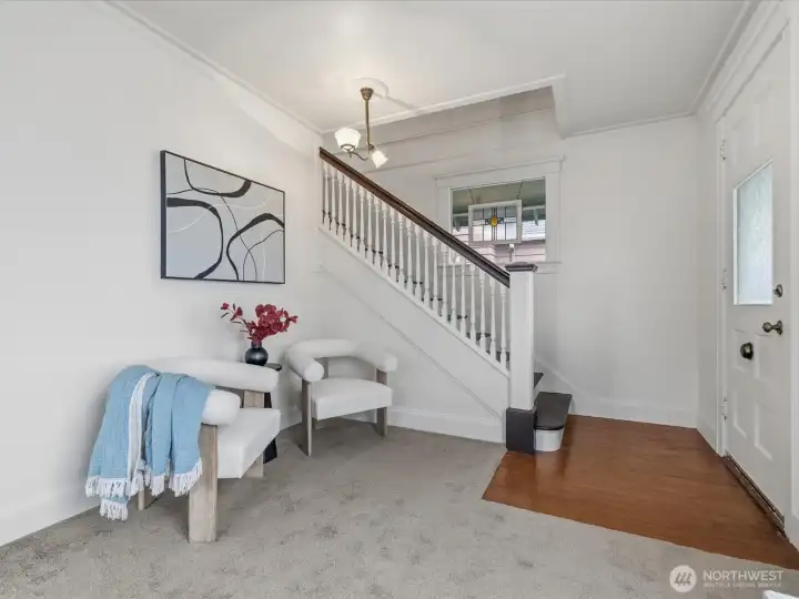 Notice the period light fixture in the entry and the beautiful, gracious open stairs and railings.