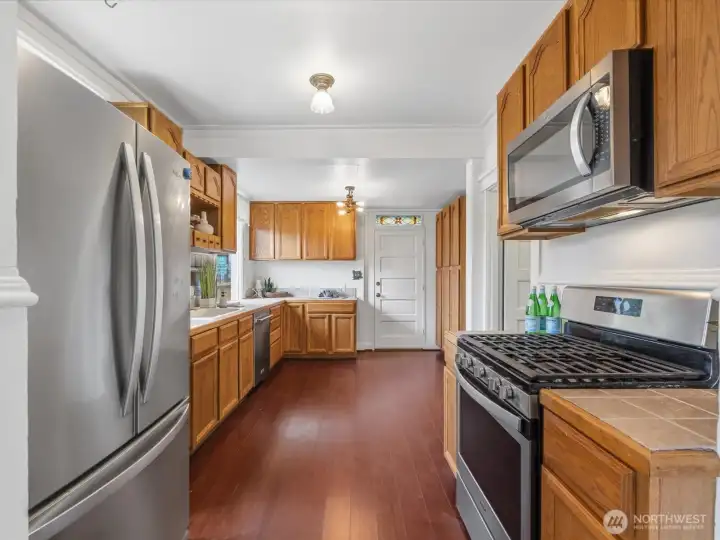 This kitchen has more than adequate storage. The door leads to the backyard.