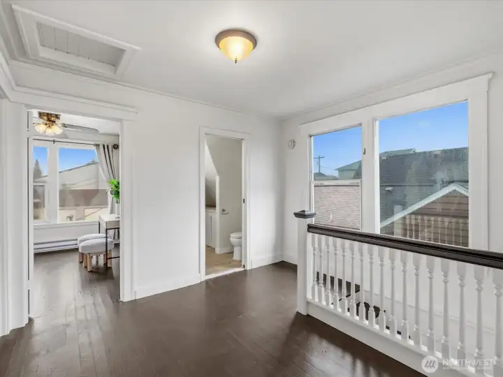 The landing on the second level is large enough for a desk or worktable. All of the big windows in this home make the entire space light, bright and very pleasant. This level has the original wood floors.
