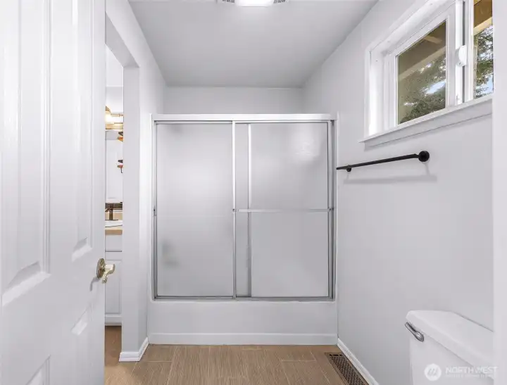 Main level full bath - jack and jill style connected to primary bedroom