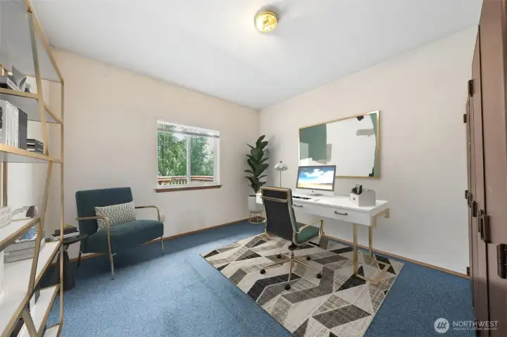 The Office, with storage, is located off the garage, and overlooks the beautiful deck and peaceful backyard. (Virtually staged).