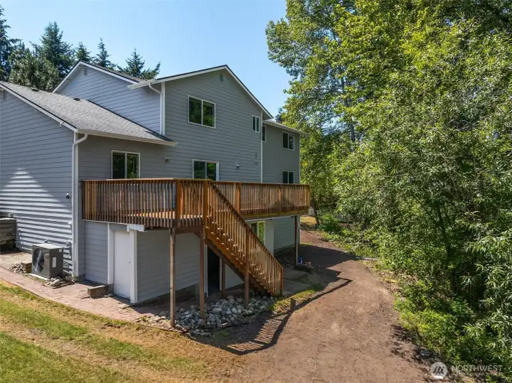Enjoy the beauty & peace of this private backyard! The doors under the deck lead to several extra storage rooms ...