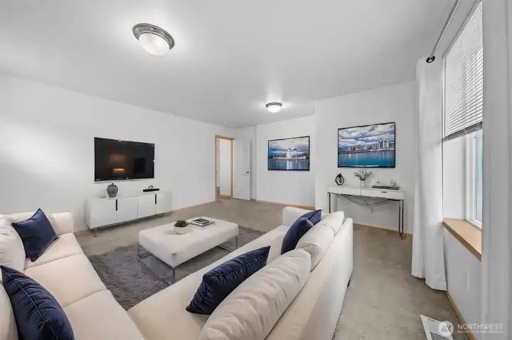 Virtually staged 3rd bedroom used as rec room/family room Virtually staged 3rd bedroom used as rec room/family room