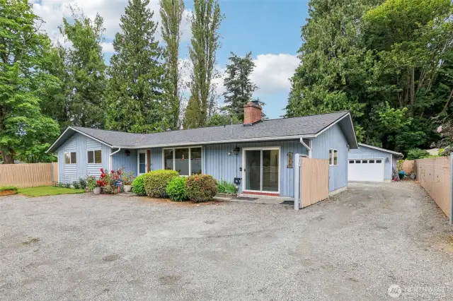 Notice the oversized, Two car plus garage as well as a separate Motorcycle-Shop ( or? Make it your own?) Garage has lots of space to store any needed outdoor items. This home is located across the street from the Lake Stevens Middle School, and High School is close as well-just East or left on 91st.