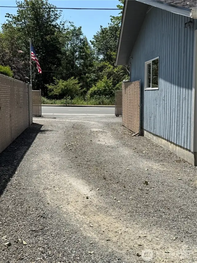The gravel is allowing the cars and trucks to have less grass to cut and more vehicles to be used and stored with room to spare