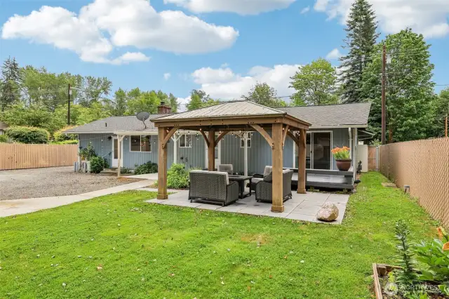 The sliding glass doors, lead to the master bedroom, the decking is custom and inviting with built in benches & stairs....leading to the covered area and the back concrete slab outside the back door. to the left ( in picture) Gas hookups for your own grill, just outside the kitchen. (This grill goes with sellers.)