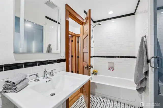 Across from second bedroom, full bathroom with nice size pedestal sink and private bathroom and shower.
