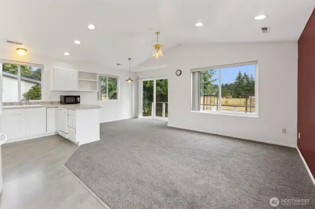 Large Living area! Dining room in the background with Sliding glass door to the wrap around deck!