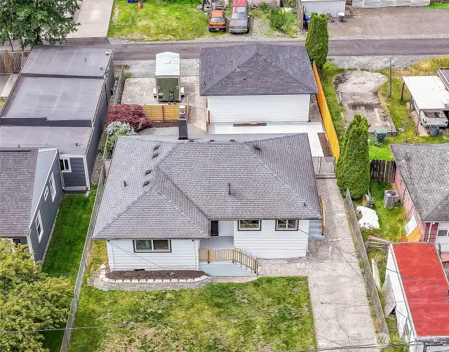 Bird’s-eye view of the home - new roof, fresh exterior paint, spacious lot & long driveway.