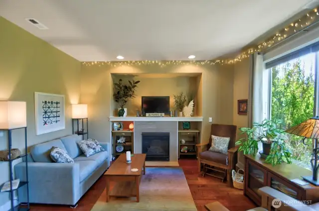 Living room features natural gas fireplace, space for theater sized TV above, large picture windows with fabulous territory views.
