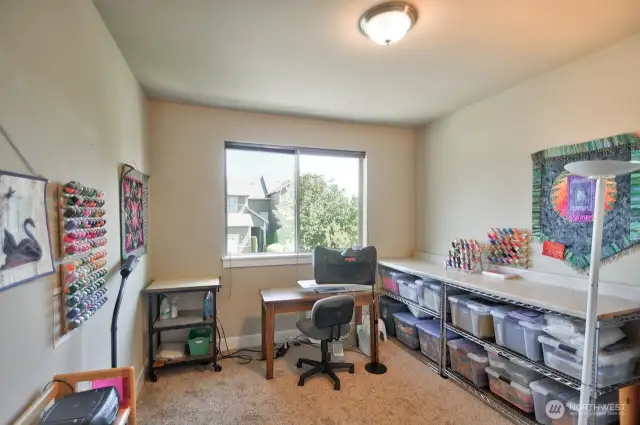 Third of three upstairs bedrooms, this one currently used as a hobby room