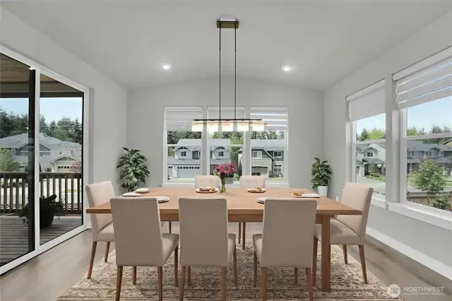 Sunroom style dining room with custom lighting, electronic Hunter Douglas window coverings. Opens to covered deck.