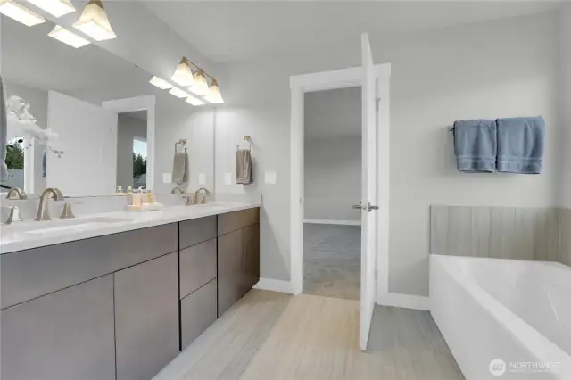 Primary bath with double sinks, walk-in shower and soaking tub.