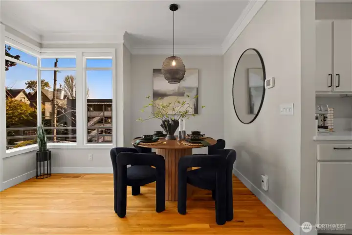 Dining room surrounded by windows.