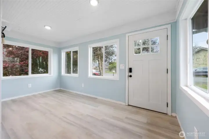 Inviting entry of the home. Lots of windows allowing natural light inside.