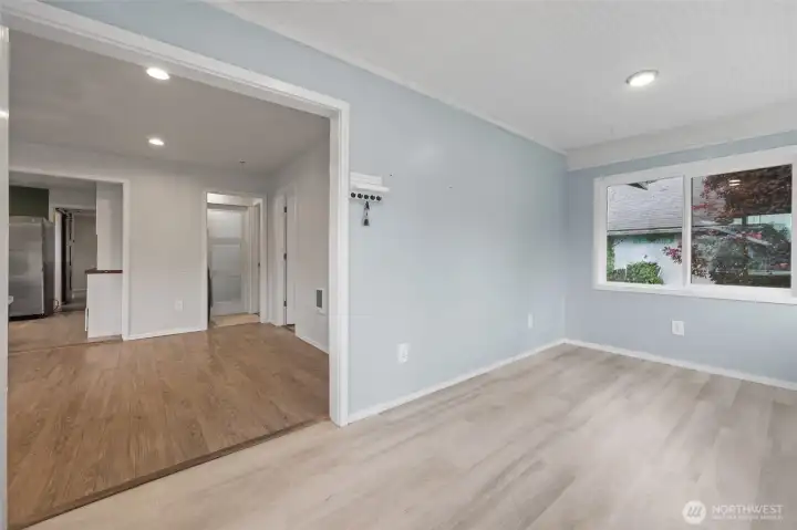From the entry room looking into the living room and kitchen beyond.
