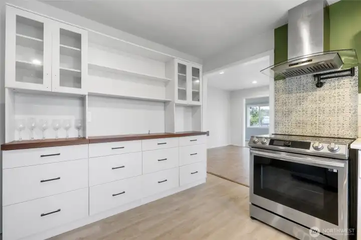 This cabinet in the kitchen offers plenty of additional storage, may be used as a coffee bar. It isn't attached and transfers with sale.