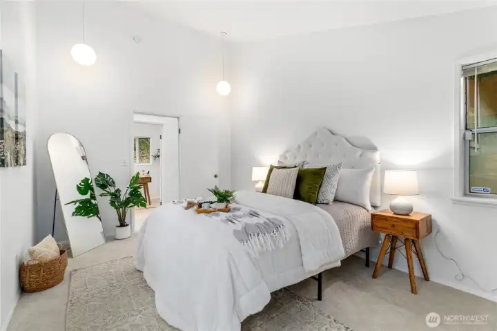 Primary bedroom has huge vaulted ceilings giving an airy feel while keeping privacy.