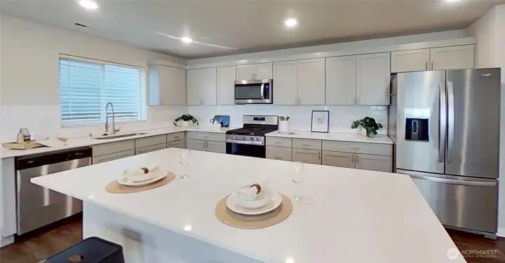 Kitchen. Quartz counters. Staged.
