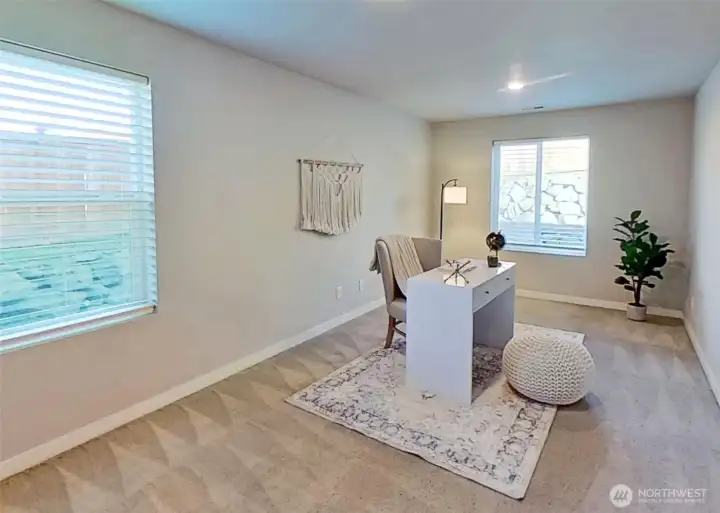 Main-level den/office/bonus room. Staged.