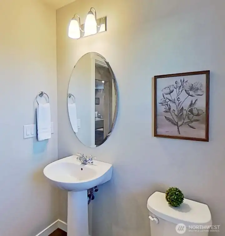 Main-level half bath. Staged.