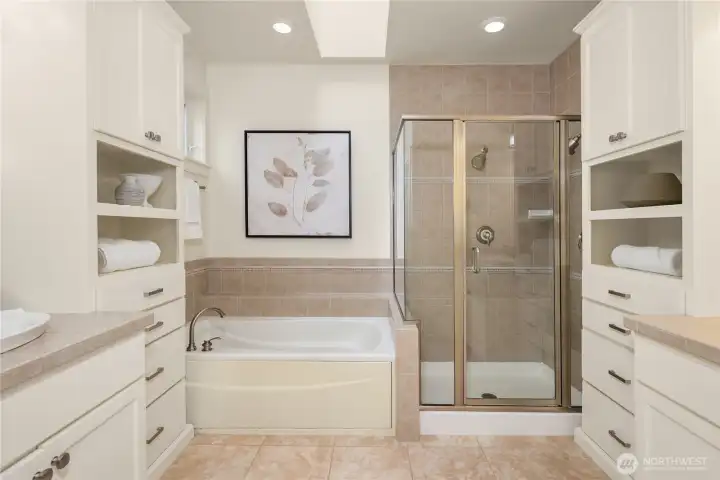 Primary bath with seperate vanites, soaking tub, shower and walk in closet