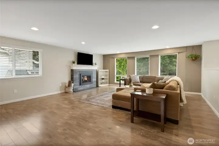 Electric fireplace offers a cozy warm blanket feel throughout the winter! Large windows give plenty of light to this spacious living room.