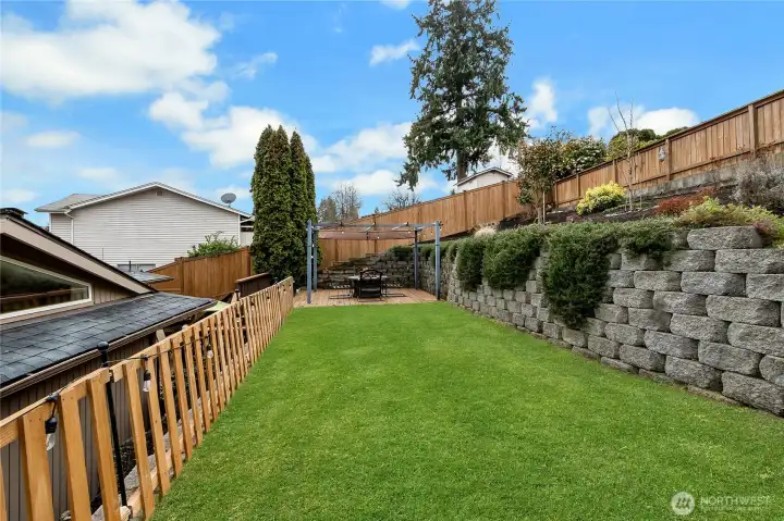 Large level lawn, perfect for family game night with bocci ball, horseshoes, cornhole and other favorite yard games! From the top corner of the yard, you can see a gorgeous peek-a-boo view of Mount Rainier!
