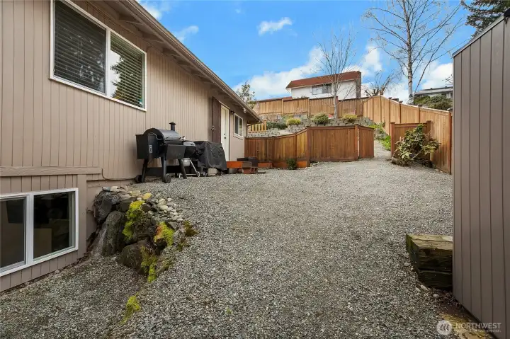 Side yard has a newer shed (2022) and offers a great space to work on your BBQ/smoker skills!