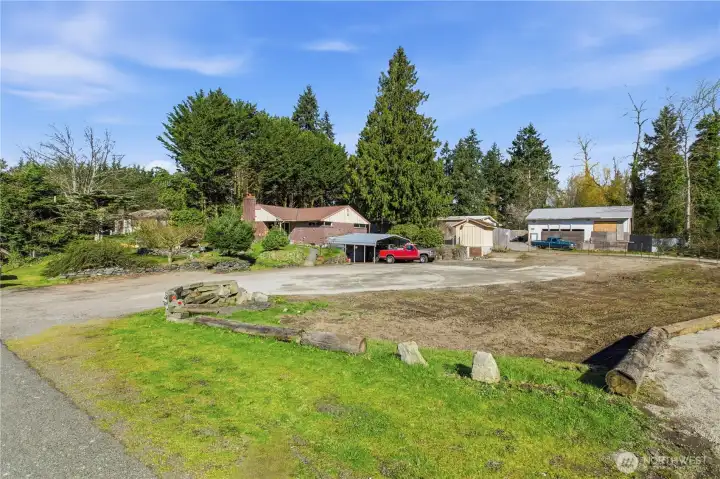 Long driveway approach with ample parking and development potential.