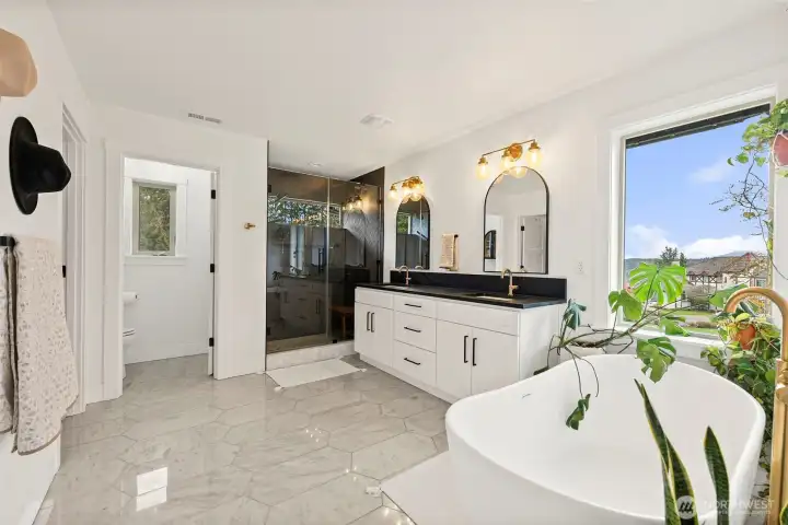 Marble tile flooring, granite counters, beautiful finishes in primary bath.