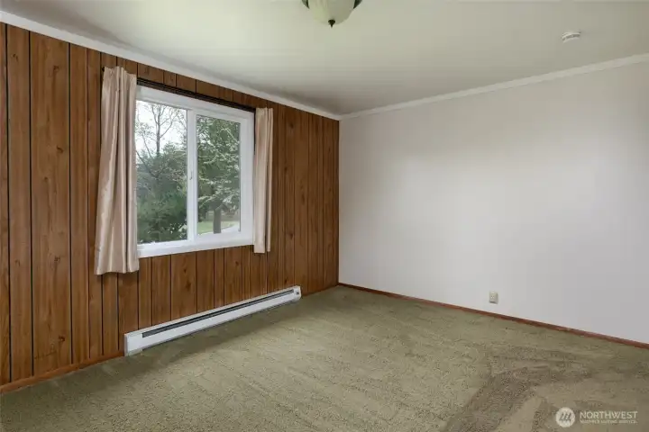 Primary bedroom looks out to leafy trees